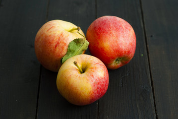 apples on black wooden table background