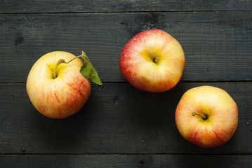 apples on black wooden table background