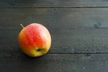 apple on black wood table background