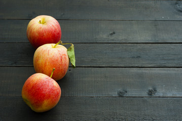 apples on black wooden table background