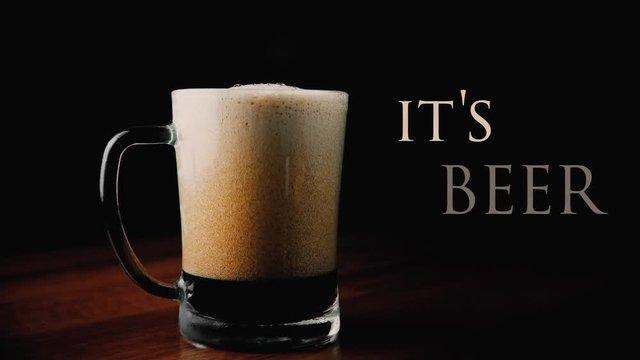 frothy dark beer in Glass