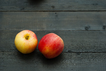 apples on black wooden table background