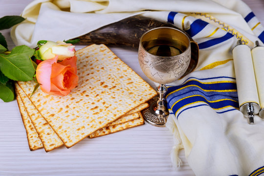 Pesah celebration concept jewish Matzoh and red sweet wine Passover holiday and spring flowers