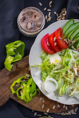 Fresh vegetables salad on plate. Slices of onion rings, tomatoes, cucumber, cabbage and capsicum. Healthy diet. Raw vegan vegetarian food