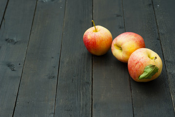 apples on black wooden table background