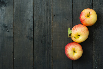 apples on black wooden table background