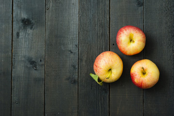 apples on black wooden table background