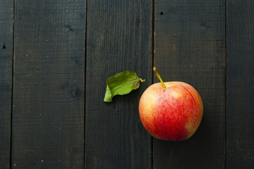 apple on black wood table background