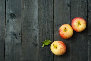 apples on black wooden table background