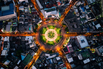 Aerial view of roundabout or circle of road with light trails on the road at night in Bangkok,Thailand. Expressway, Highway, Motorway, Tollway at Bangkok city downtown. - obrazy, fototapety, plakaty