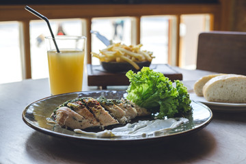 Lunch in restaurant. Meat with salad and glass of juice.