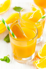 Orange Juice on White Wooden Background. Selective focus.