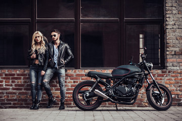 Naklejka na ściany i meble Romantic couple with motorcycle