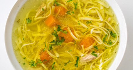 Chicken or beef soup with noodles carrot and parsley herb