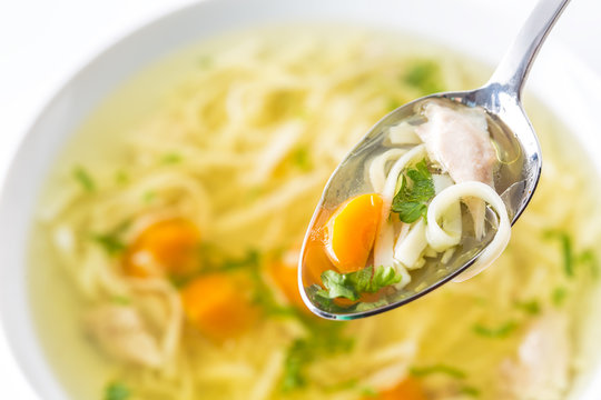 Spoon Full Of Chicken Or Beef Soup With Noodles Carrot And Herbs