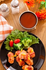 Fried sausages and vegetables with sauce.