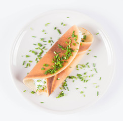 Pancake with cottage cheese and chives decorated with basil