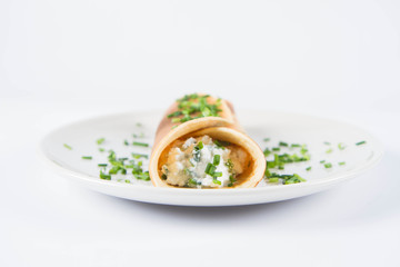Pancake with cottage cheese and chives decorated with basil