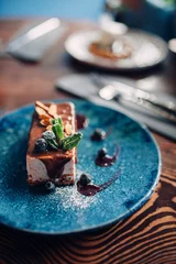Rolgordijnen Sweet dessert on a plate on wooden table, nobody © Nomad_Soul