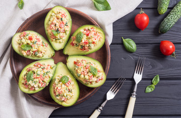 Avocado stuffed with cucumber , tomatoes and eggs