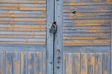 wooden door with a lock on an old wooden house