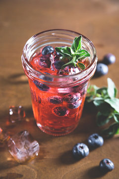 Natural lemonade with fresh blueberries and herbs
