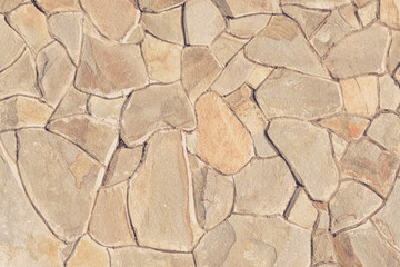 Wall of natural brown stone. Close up