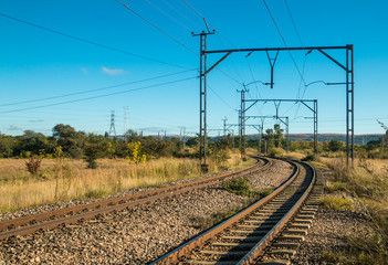 Electric railway lines going through a rural landscape