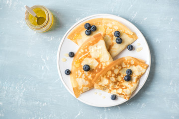 Crepes with blueberries and honey