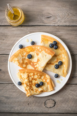 Crepes with blueberries and honey