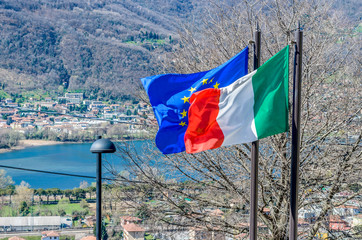 Italian and European flags waving in a sunny day