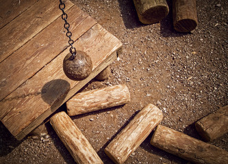 Ball on chain breaking wooden cylinders. Concept: relations destruction, unforeseen circumstances,...