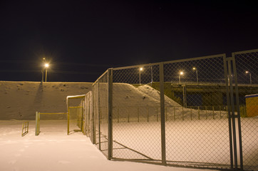 fence in the mesh in the winter on the street