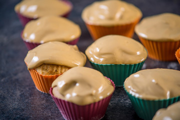 Homemade freshly made cupcakes in silicone molds on dark background. Concept of confectionery cooking