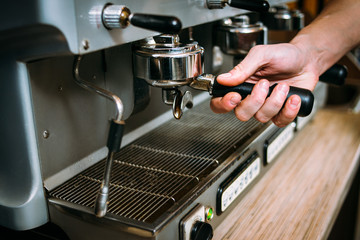 coffee brewing process. professional barista preparing drink in the machine