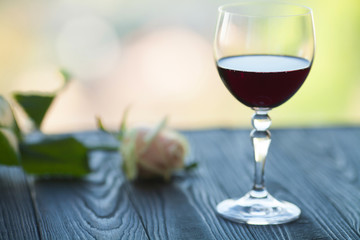 Red wine with and white roses. Romantic dinner. Evening of a lonely woman.