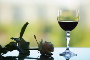 Glass of red wine on a gloomy background. unhappy love. Bed evening.