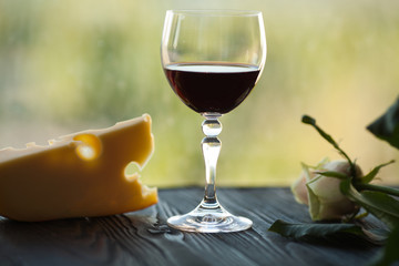 Glass of red wine with cheese. Romantic dinner with red wine.