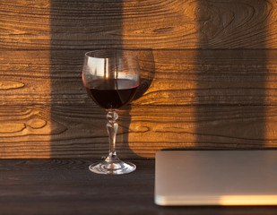 Red wine with cheese on wooden dark table. Romantic date with flower and wine.