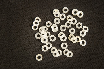 Many crochet elastic bands lie on black stuff