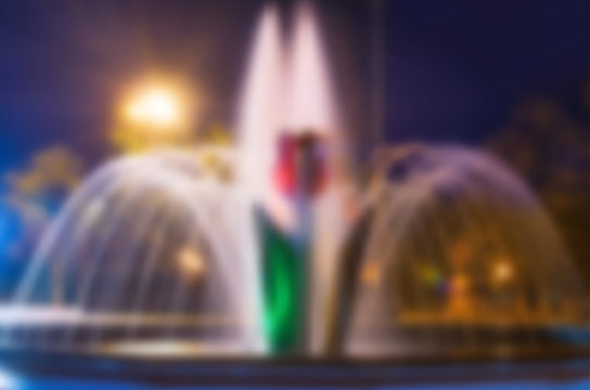 Beautiful night blurred background with tulip flower fountain in Pokrow city Ukraine. City evening illumination. Vecror illustration eps 10