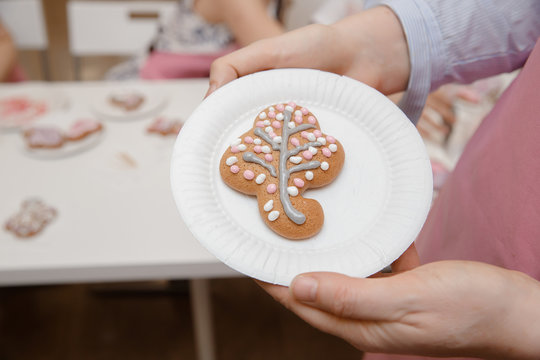 Decorating ginger cakes colored glaze, child paints cookies