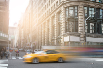 New York City yellow taxi speeding through Manhattan street