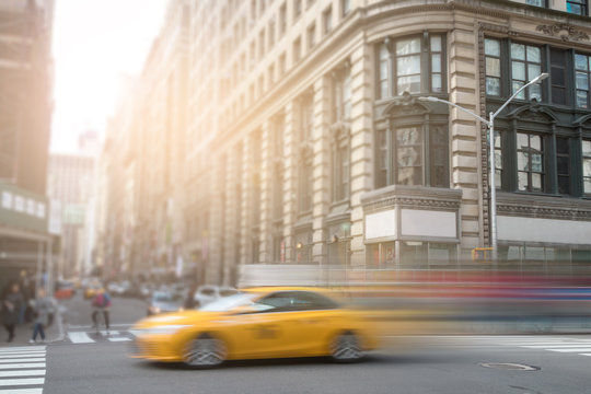New York City yellow taxi speeding through Manhattan street © deberarr
