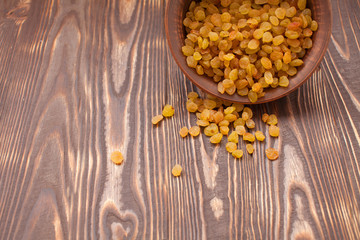 bowl of raisins. raisins on a wooden background.fresh raisin
