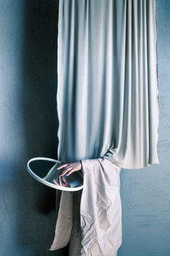 person hiding and holding a mirror