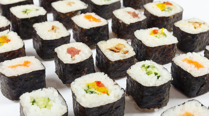 Assorted japanese sushi on a white background close up.