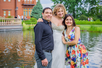 Fototapeta na wymiar Bride with girlfriend and groom on a happy day celebrate the event 