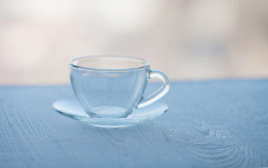 Empty glass cup on wooden table.