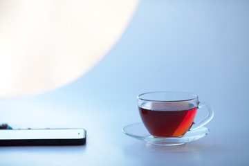 A Cup of freshly brewed black tea,escaping steam